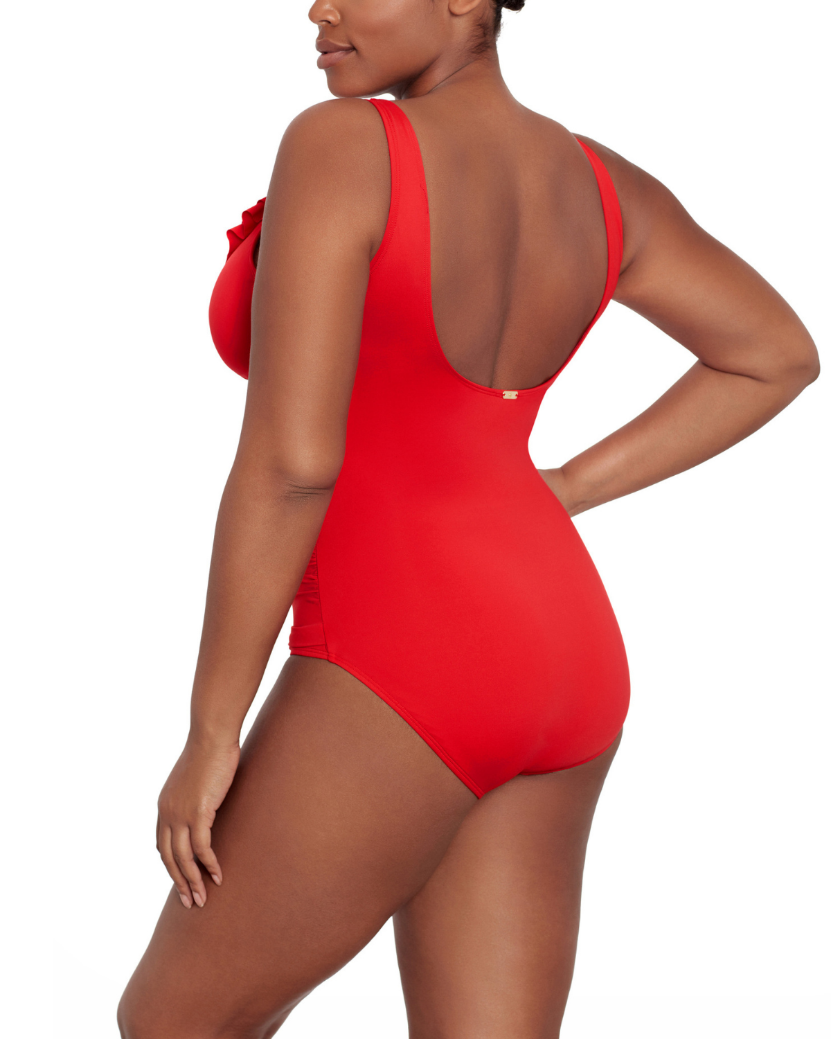 Model wearing a v-neck one piece with a ruffle trim and shirred panel around the torso in red
