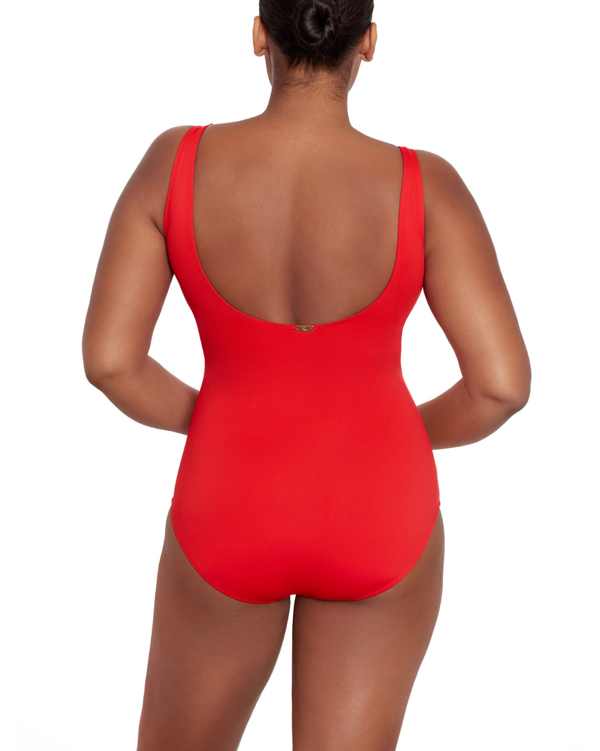 Model wearing a v-neck one piece with a ruffle trim and shirred panel around the torso in red