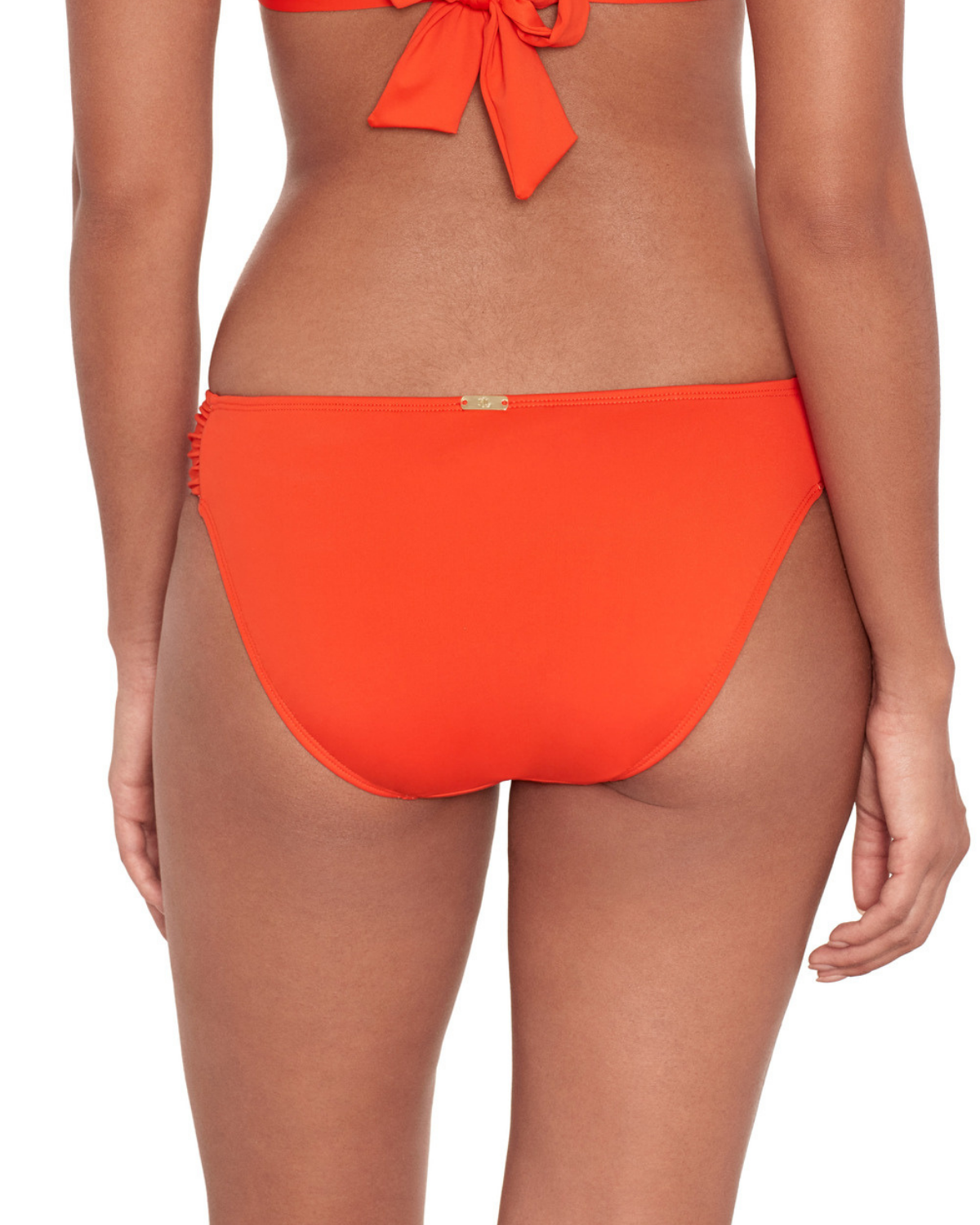Model wearing a tab side hipster bikini bottom in orange