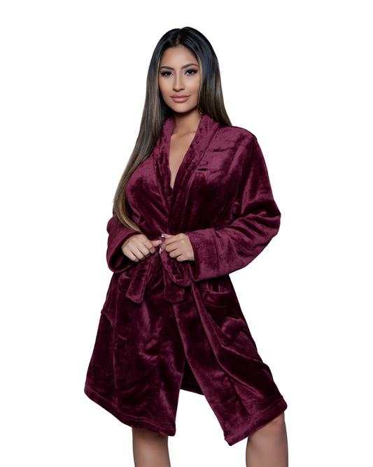 Model wearing a knee length plush robe in a maroon