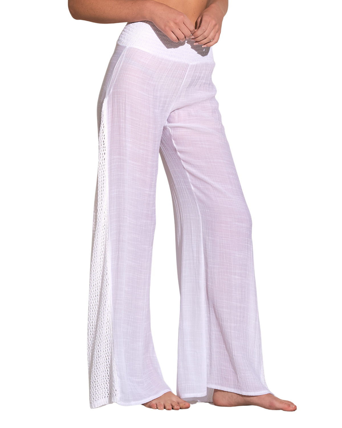 Model wearing a cover up pant with crochet side detail in white