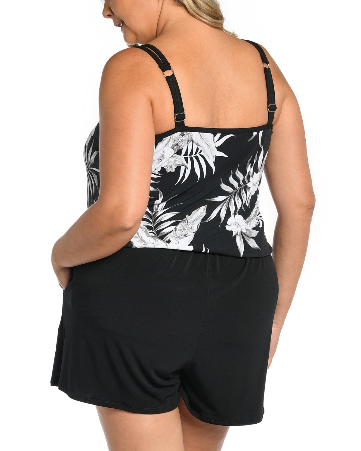 Plus size model wearing a swim romper with a a white and black floral print