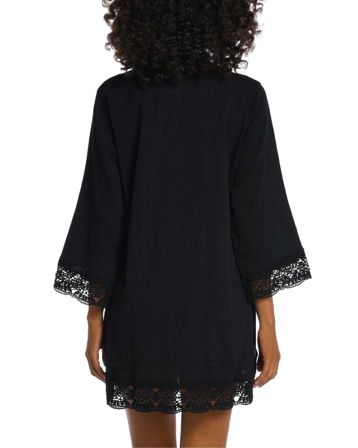 Model wearing a 3/4 sleeve v-neck tunic with a crochet trim in black
