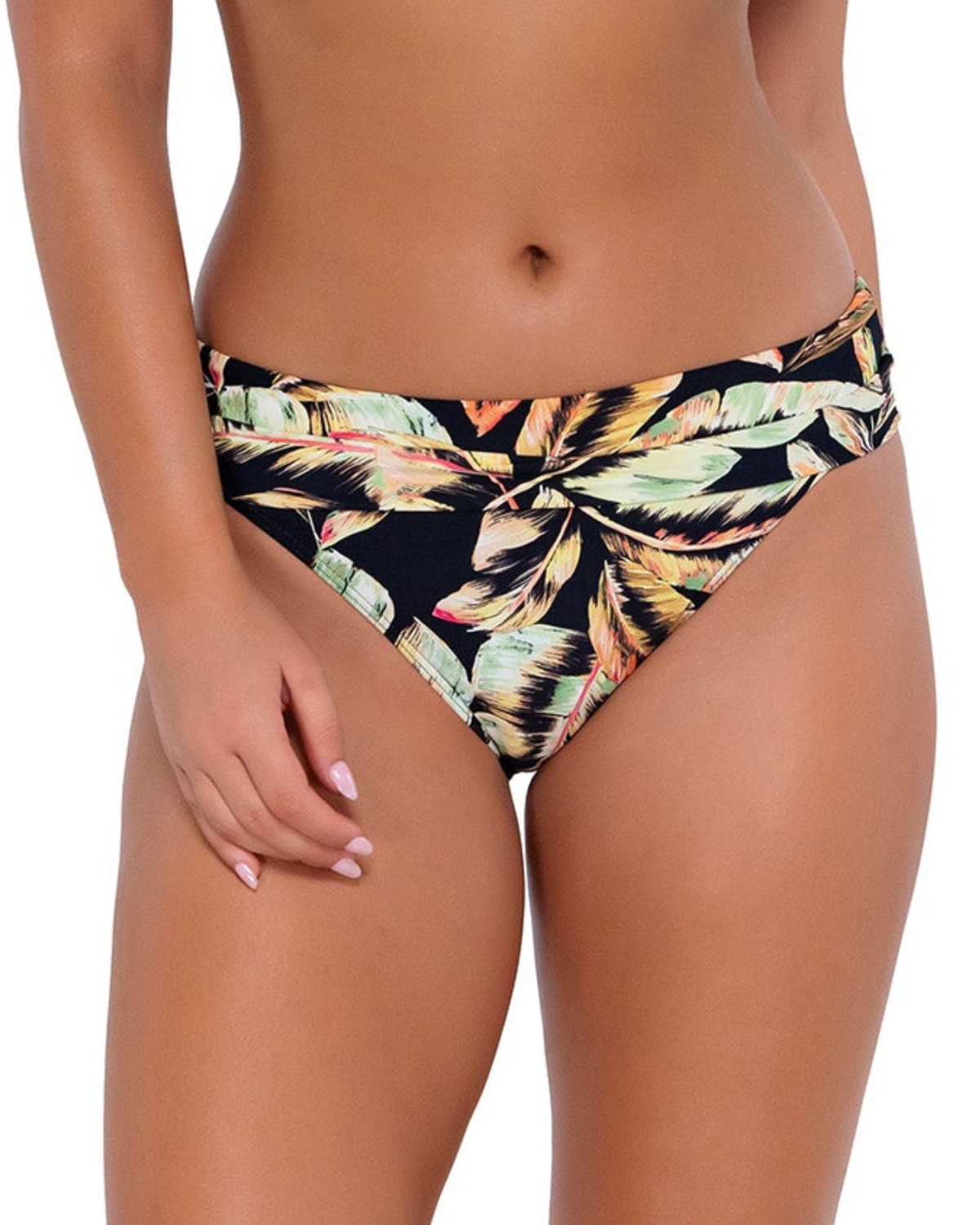 Model wearing a high waist fold over bikini bottom in a black, green and red tropical print. 