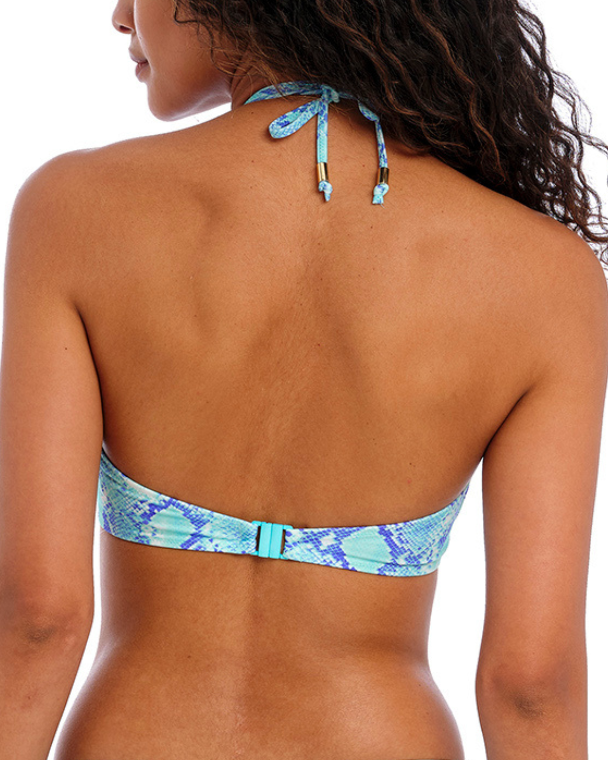 Model wearing a halter bikini top in a turquoise and blue snake print