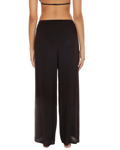 Model wearing wide leg cover up pants in black