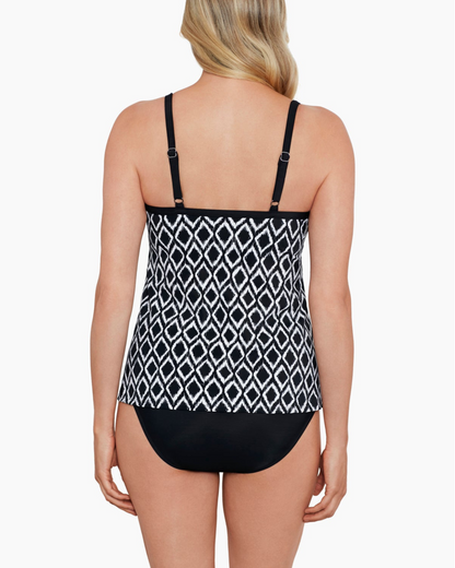 Model wearing a flyaway tankini top in a black and ivory ikat print