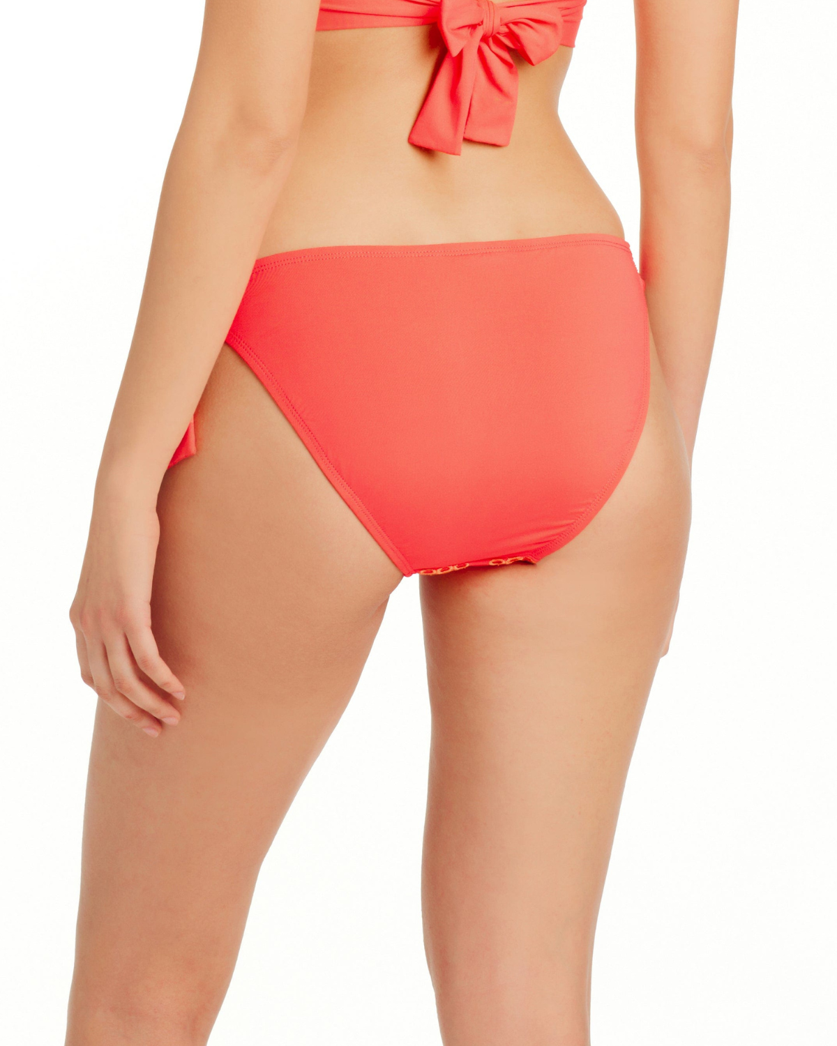 Model wearing a classic tie side bikini bottom in coral