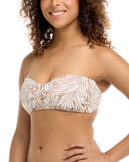 Model wearing a multi way bandeau top with a leaf print in white and beige