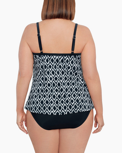 Model wearing a plus size flyaway tankini top in a black and ivory ikat print
