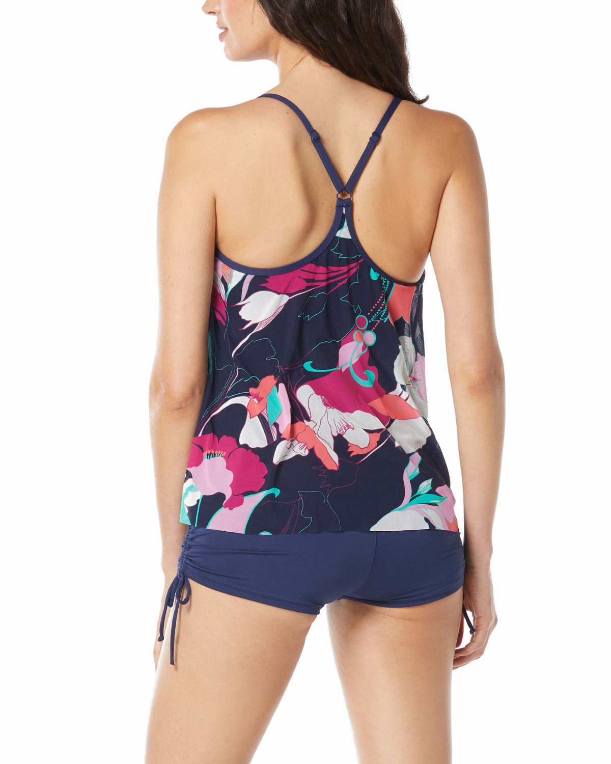 Model wearing a mesh layer tankini top in a navy, pink, orange, and blue abstract floral print