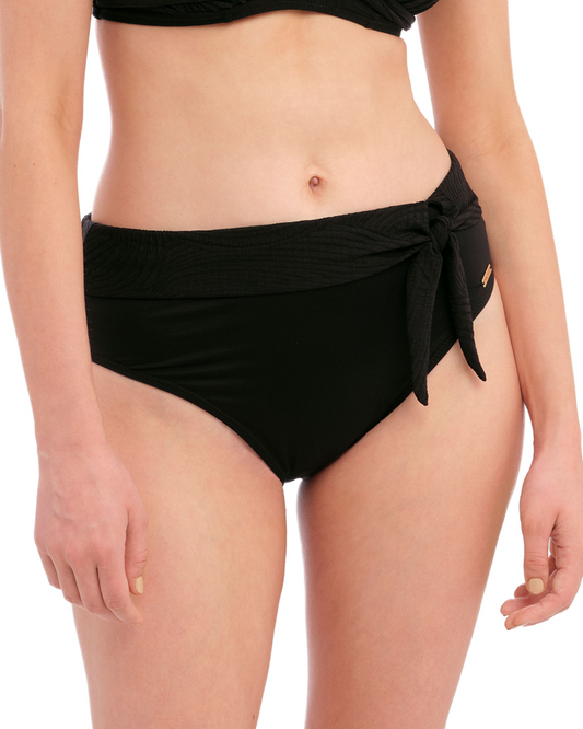 Model wearing a high waist bikini bottom with a side tie in black