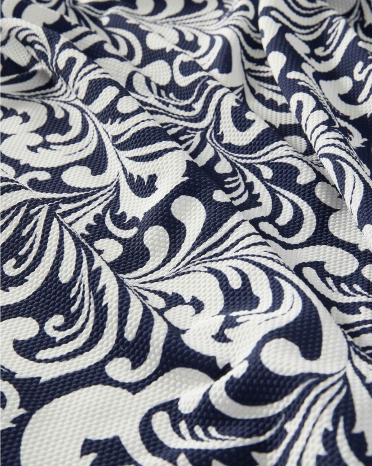 Color swatch of a navy and white scroll print