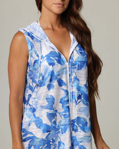 Model wearing a zip up sleeveless hoodie dress cover up in blue and white floral print
