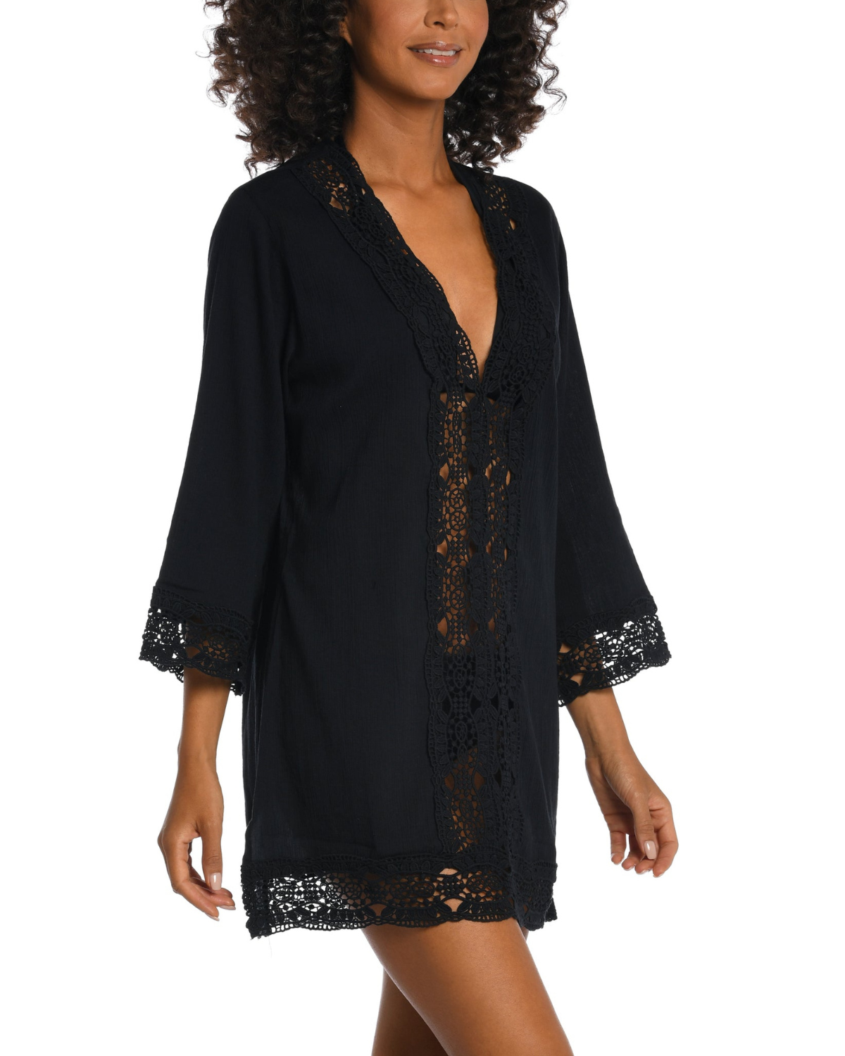 Model wearing a 3/4 sleeve v-neck tunic with a crochet trim in black