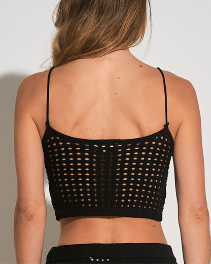 Model wearing a cropped crochet top in black