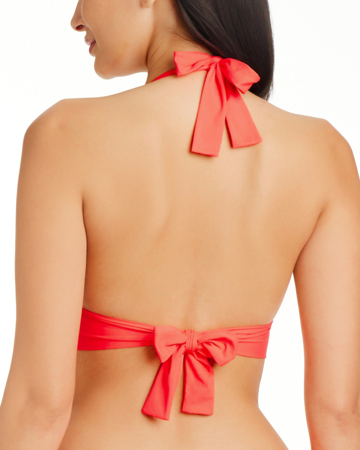 Model wearing a halter bikini top in coral