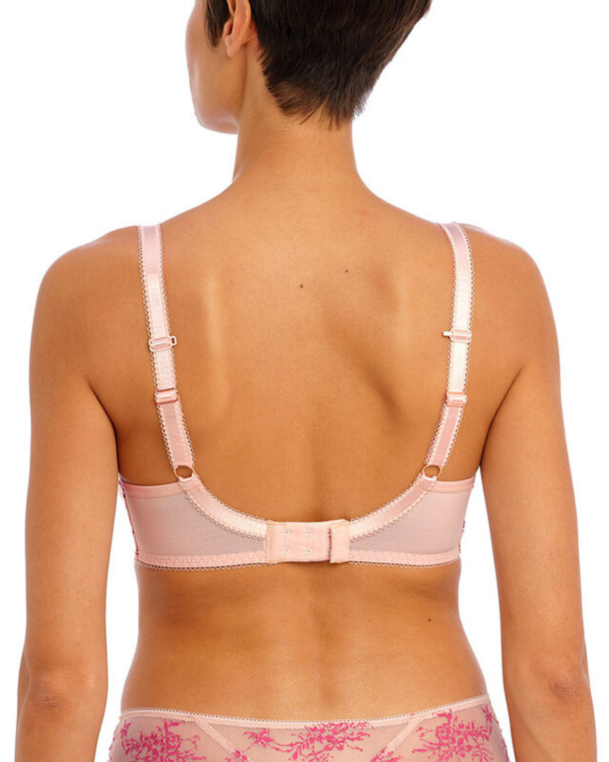 Model wearing a molded spacer underwire bra in pink with lace wings
