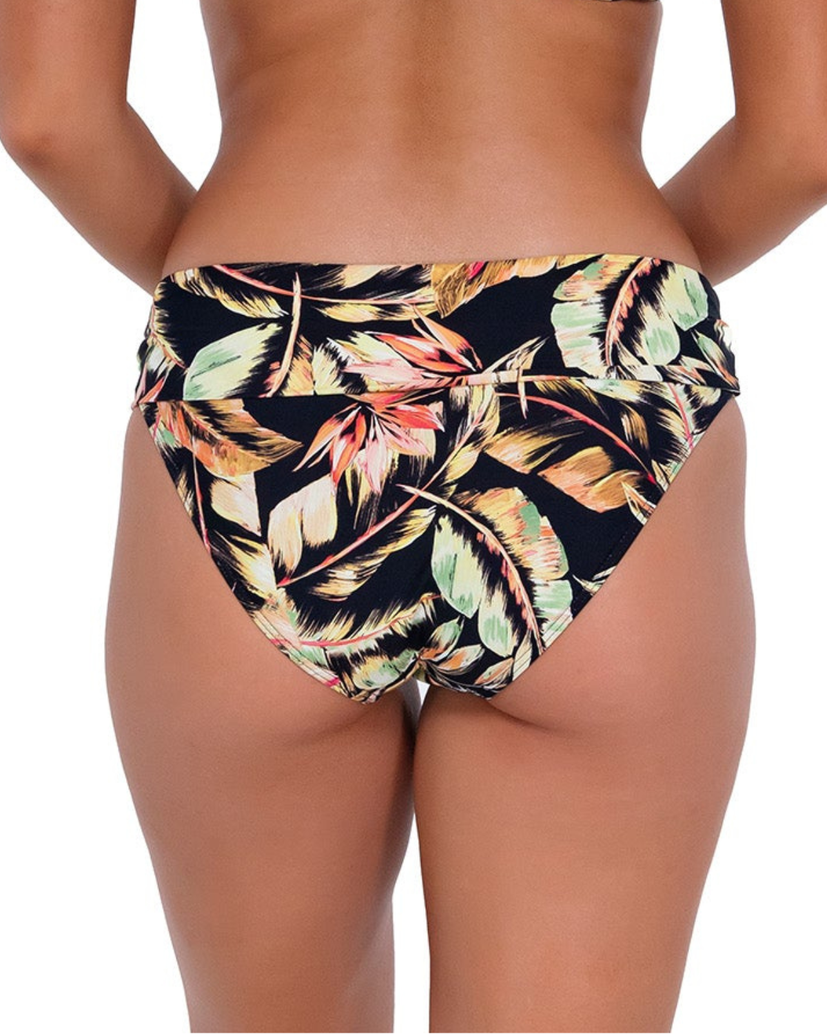 Model wearing a high waist fold over bikini bottom in a black, green and red tropical print. 