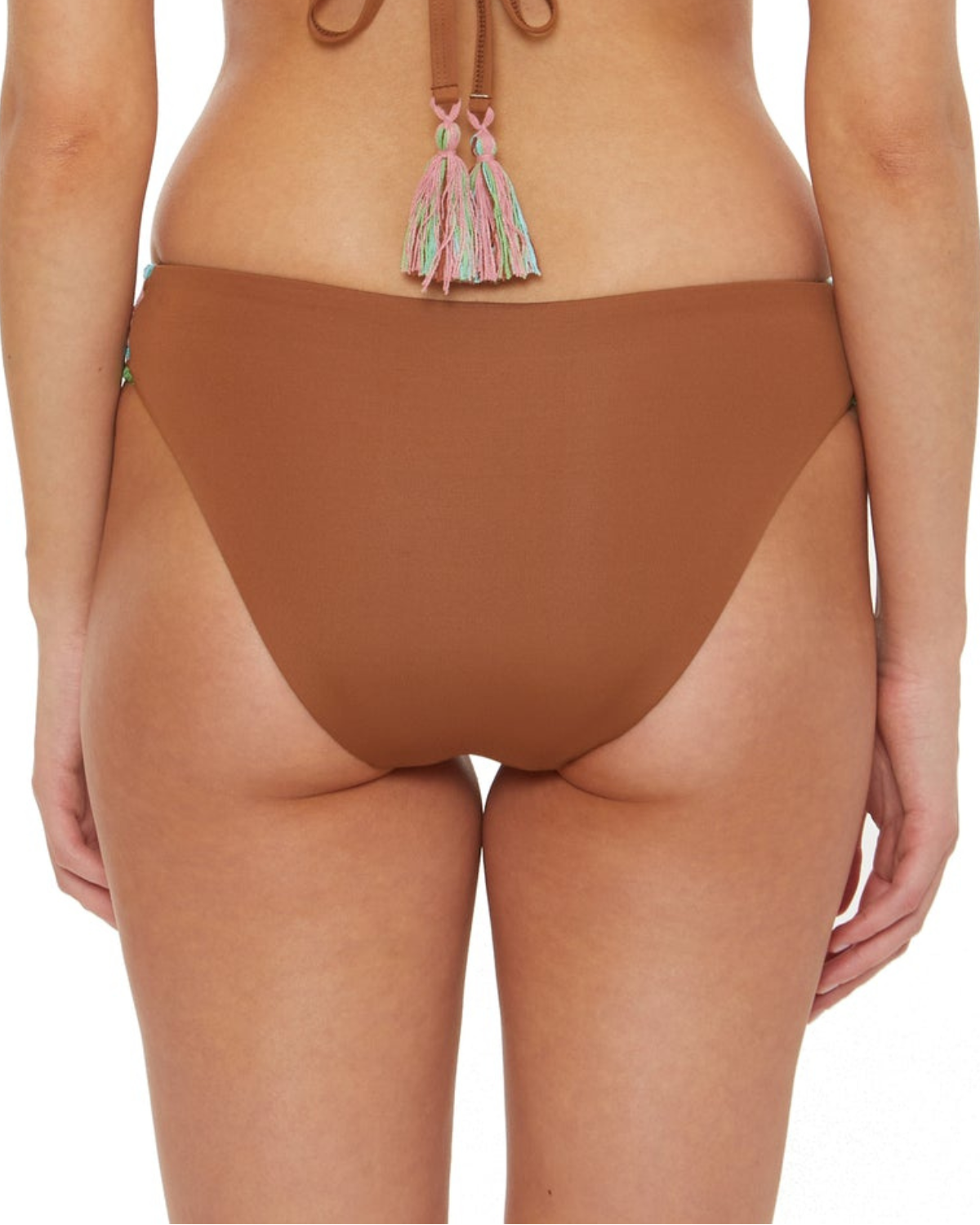 Model wearing a hipster bikini bottom in brown with crochet tab side detail in brown, turquoise, pink and green