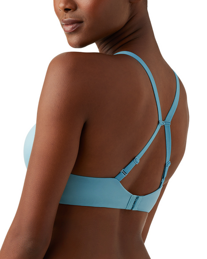 Model wearing a wire free molded bra in light blue
