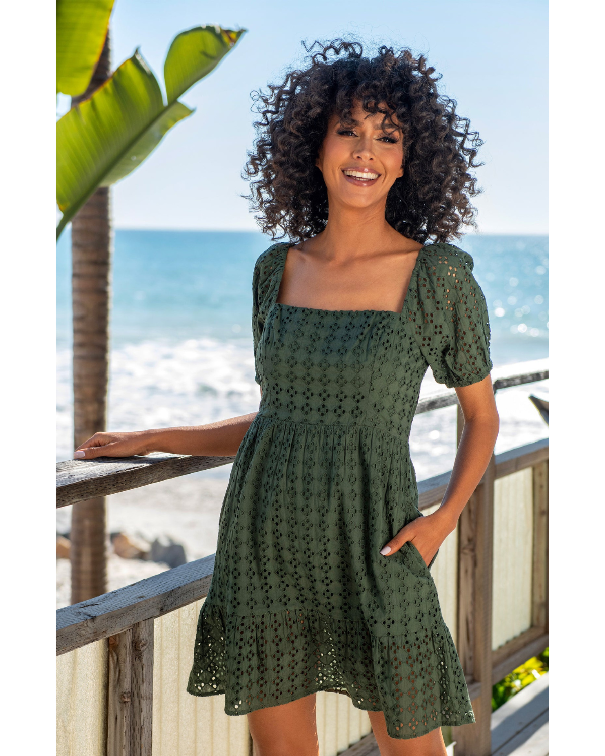 Model wearing a short sleeve cover up dress in forest green
