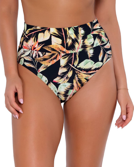 Model wearing a high waist fold over bikini bottom in a black, green and red tropical print. 