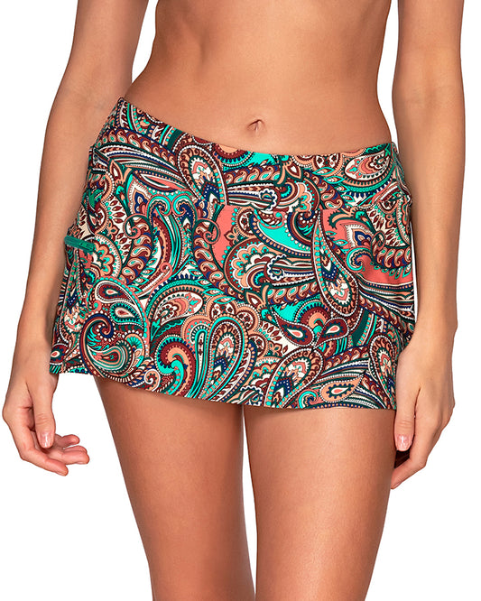 Model wearing a swim skirt with a pocket and hidden shorts in a brown, turquoise and navy paisley print. 