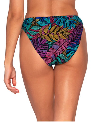Model wearing a hipster bikini bottom in a pink, purple, blue and yellow palm frond print.