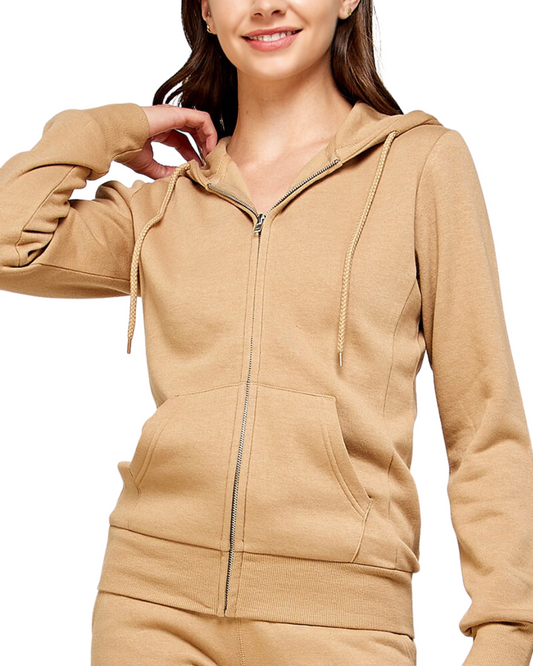 Woman wearing a basic fleece zip up hoodie sweater in light tan