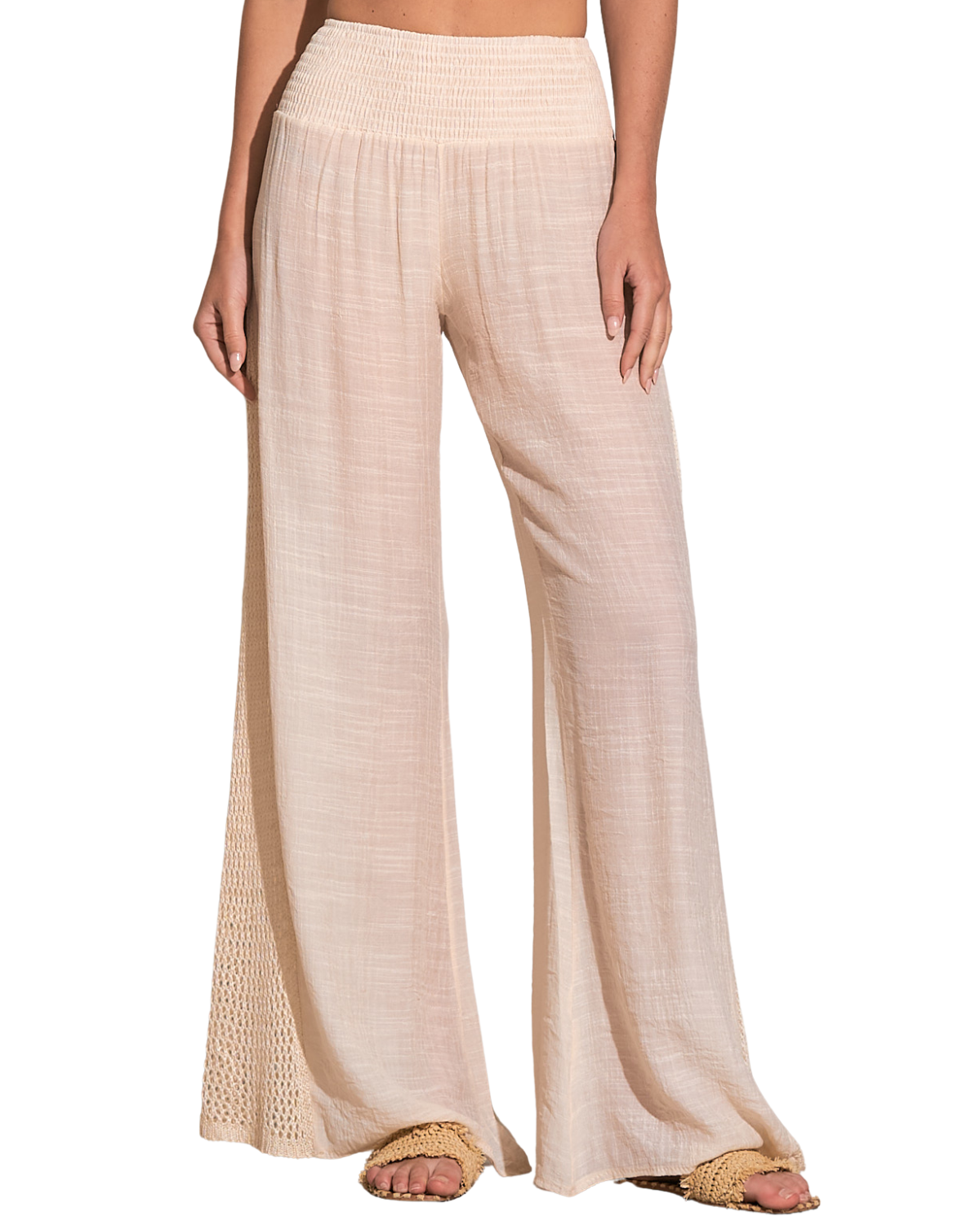 Model wearing a cover up pant with crochet side detail in beige