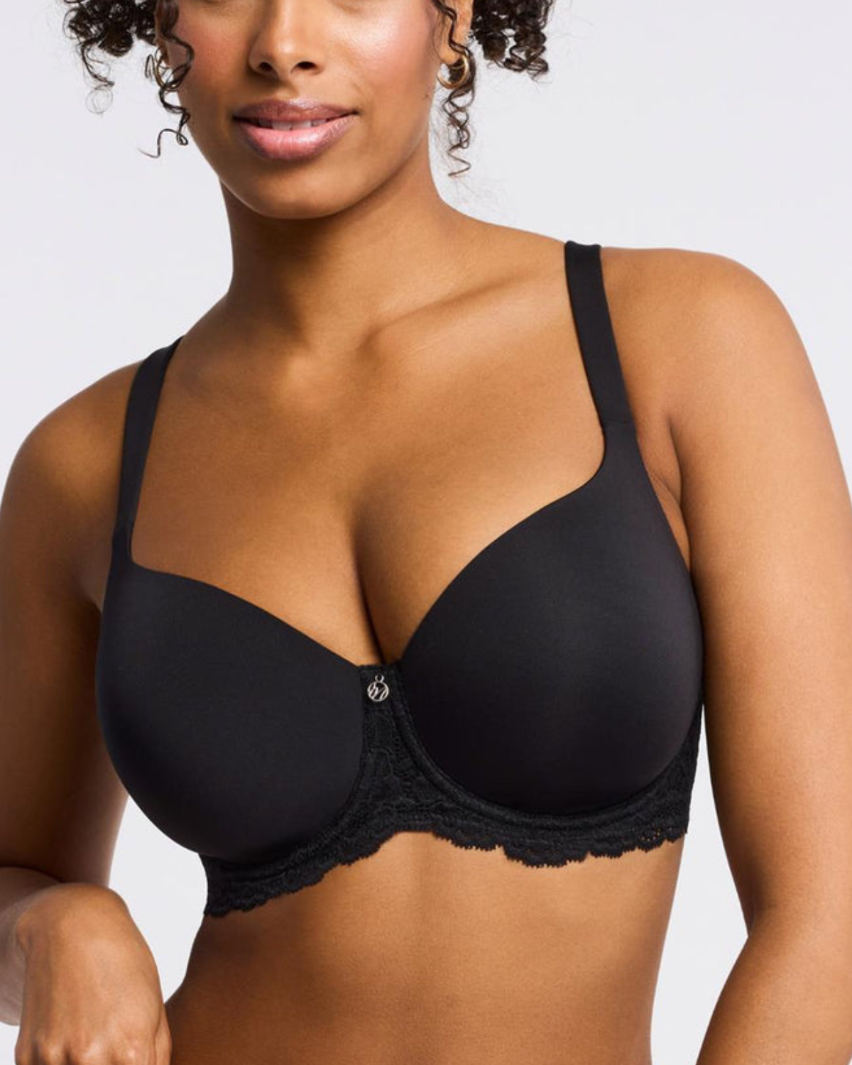 Model wearing a molded t-shirt underwire bra with lace side wings in black