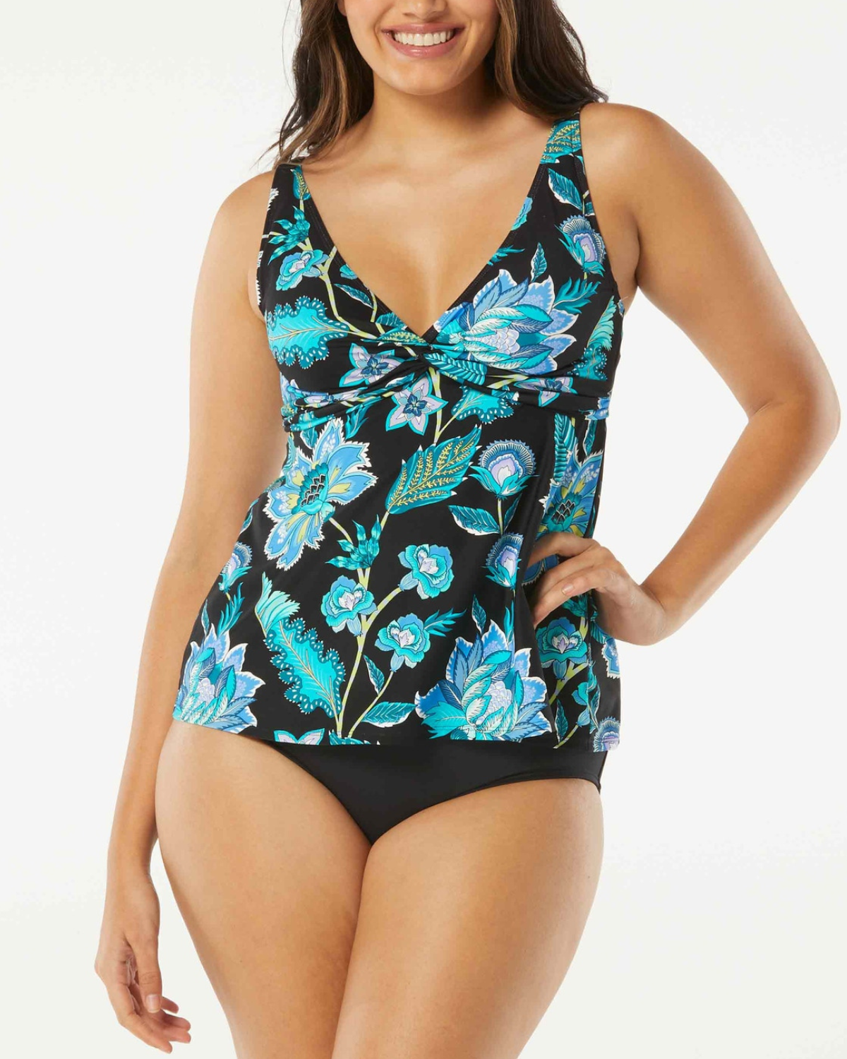 Model wearing a v neck tankini top in black with a green and blue floral print