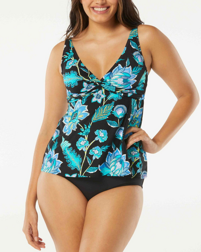 Model wearing a v neck tankini top in black with a green and blue floral print