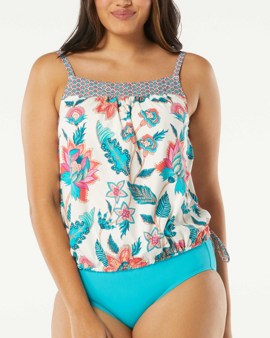 Model wearing a blouson tankini top with a floral print in white, blue, orange and pink.