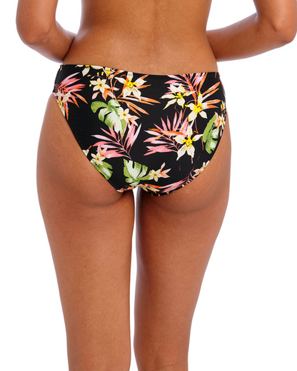 Model wearing a bikini brief with a floral print against a black base