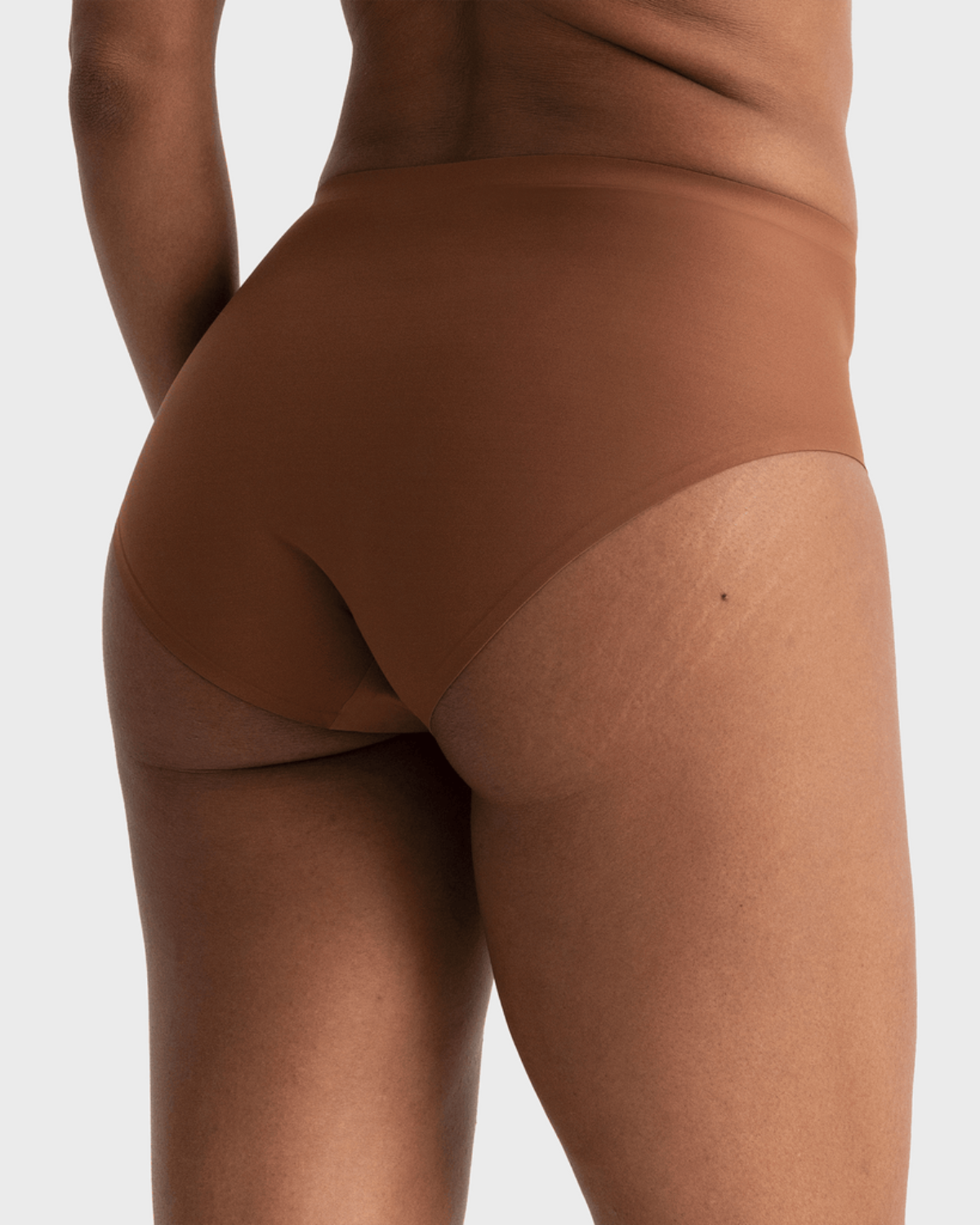 Model wearing a dark nude high waist seamless brief panty