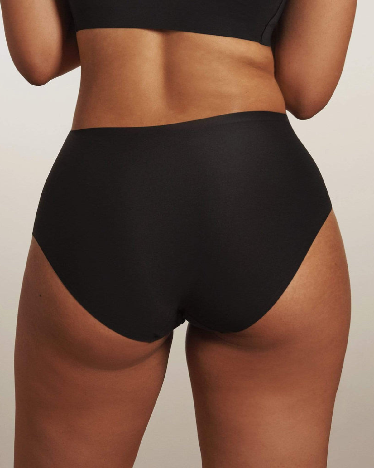 Model wearing a black high waist seamless brief panty