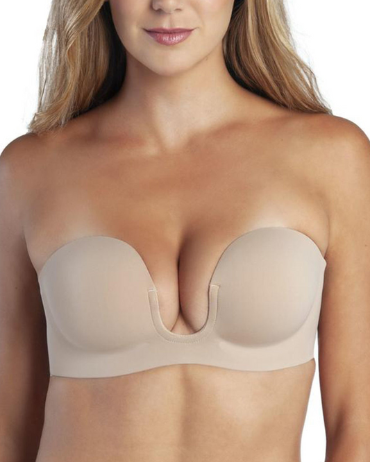 Model wearing a backless strapless adhesive bra with u-plunge in nude.