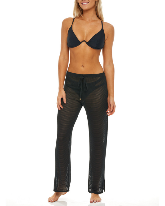 Model wearing a cover up pant in black