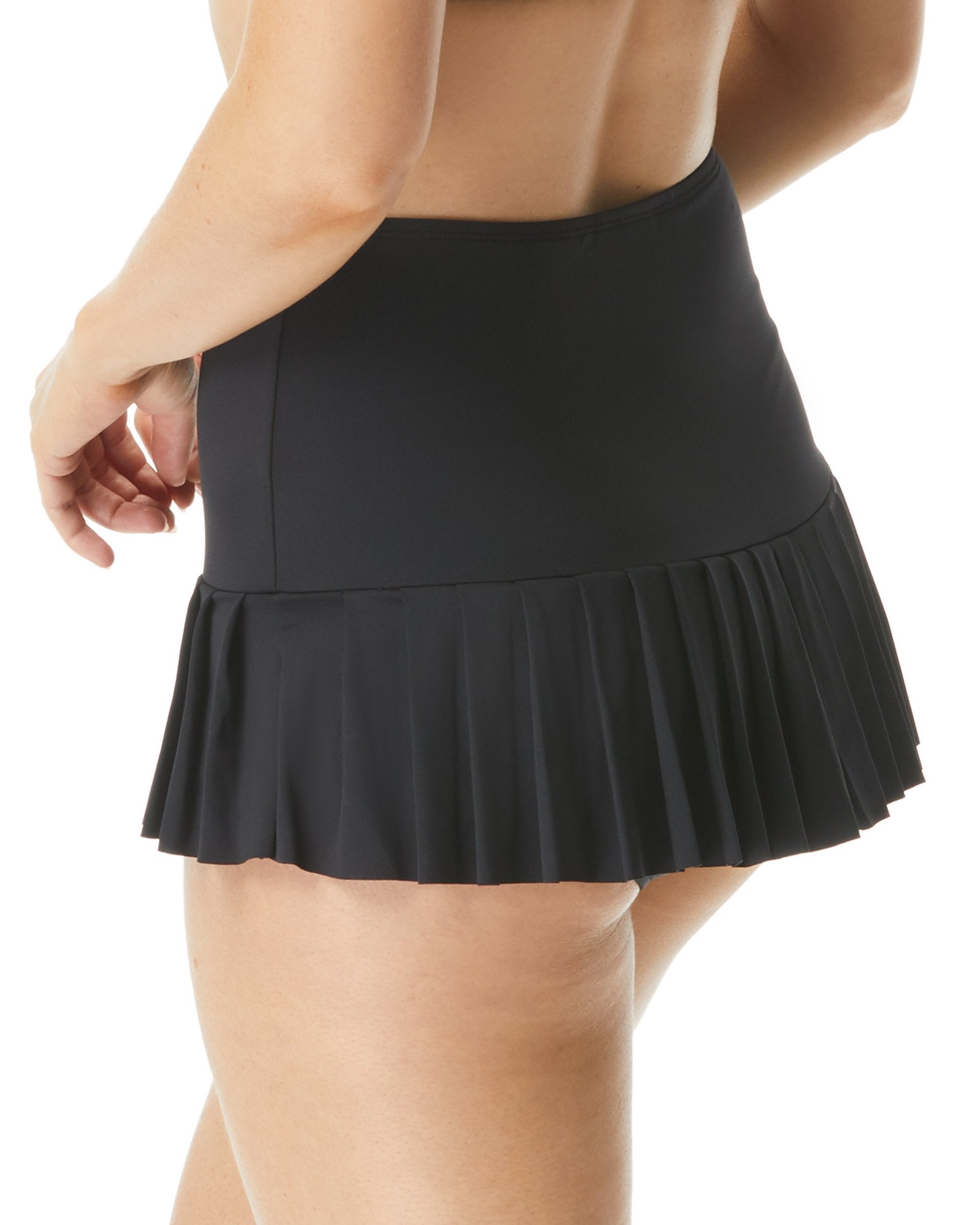 Model wearing a pleated swim skirt in black