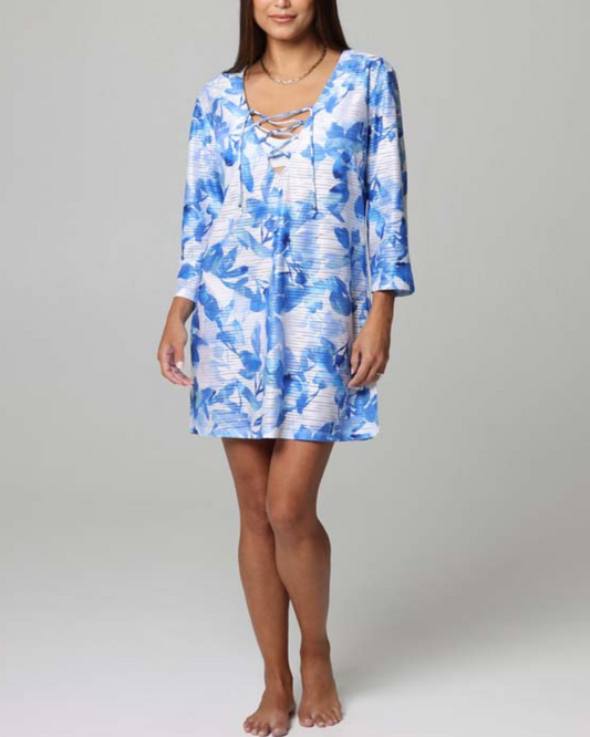 A model wearing a 3/4 sleeve dress with a v neck and lace up detail in a white and blue floral print