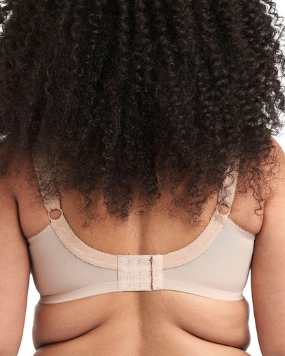 Model wearing a cut and sew banded underwire bra in light beige
