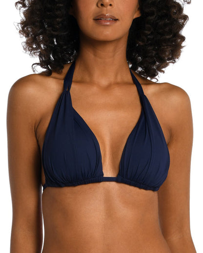 Model wearing a halter triangle top in navy