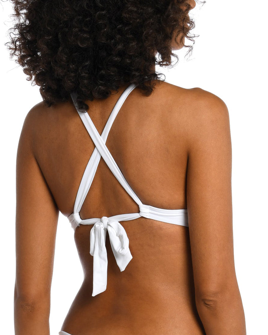Model wearing a keyhole twist front banded bikini top in white