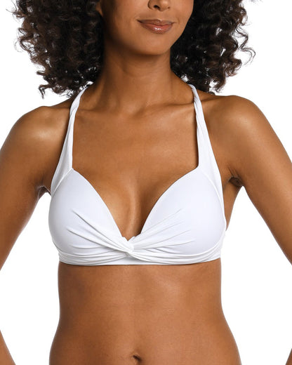 Model wearing a keyhole twist front banded bikini top in white