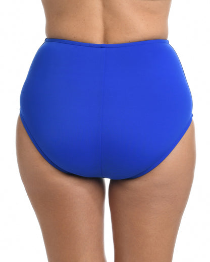 Model wearing a full brief bikini bottom in cobalt blue