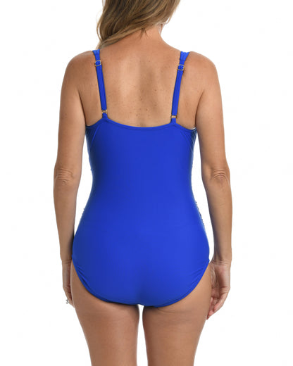 Model wearing a one piece swimsuit with a twist front detail in cobalt