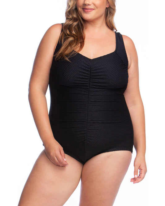 Plus size model wearing a textured one piece swimsuit with a girl leg cut in black