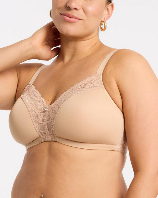 Model wearing a wire free molded cup bra with lace wings in beige